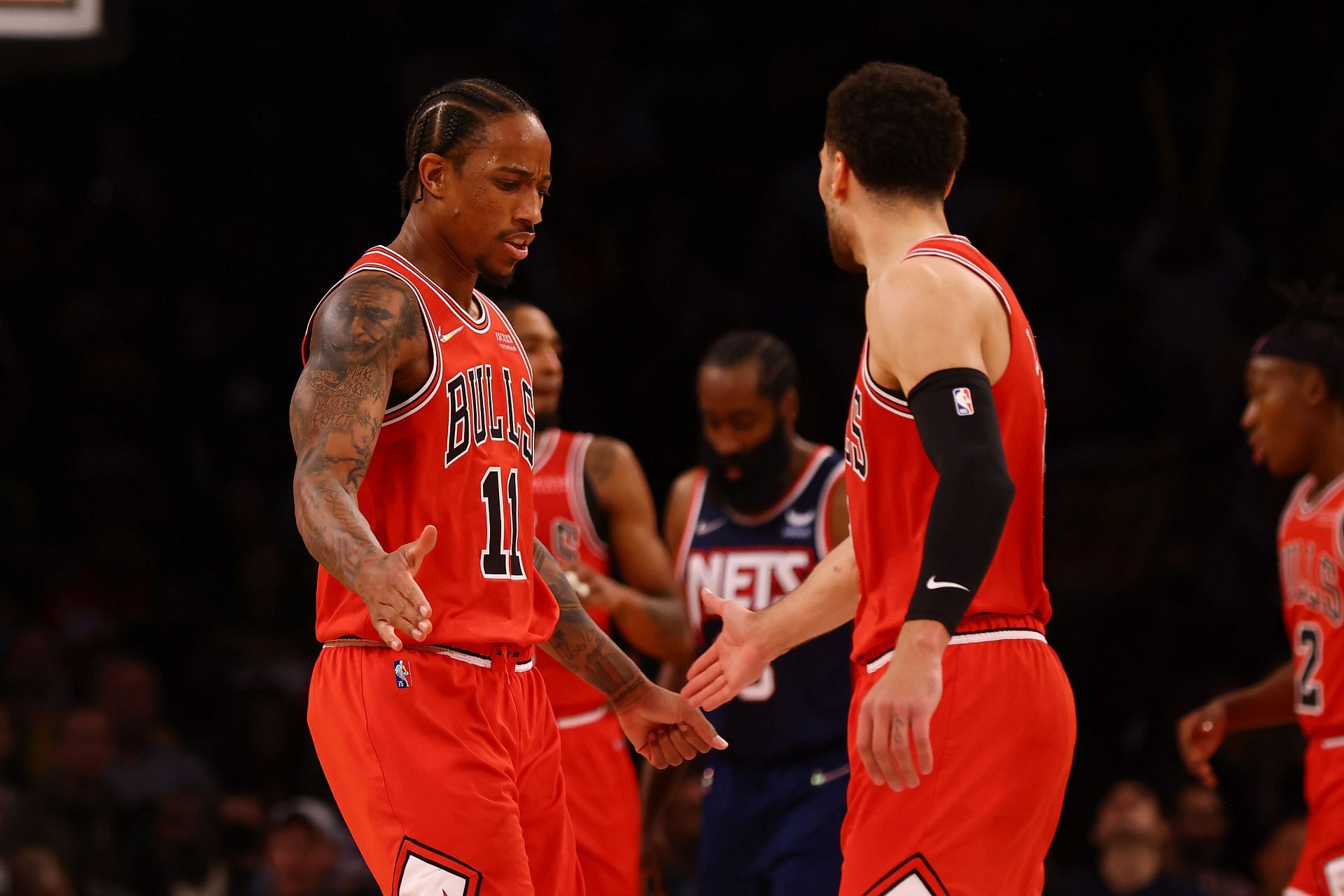 DeMar DeRozan and Zach LaVine of the Chicago Bulls shake hands in a game against the Brooklyn Nets.