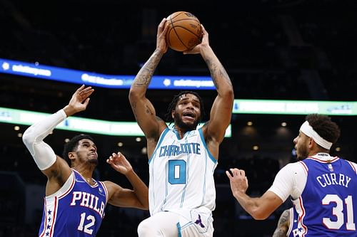 Miles Bridges #0 of the Charlotte Hornets drives to the basket against Tobias Harris #12 and Seth Curry #31 of the Philadelphia 76ers