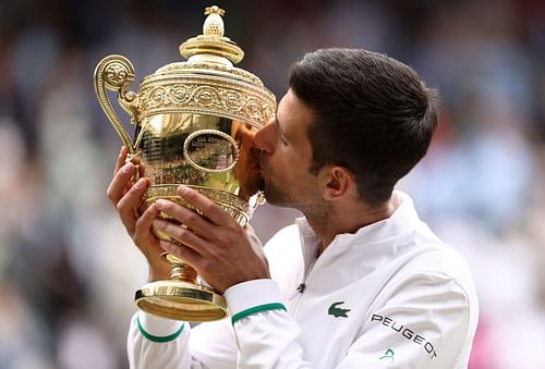 Novak Djokovic lifts the Wimbledon trophy