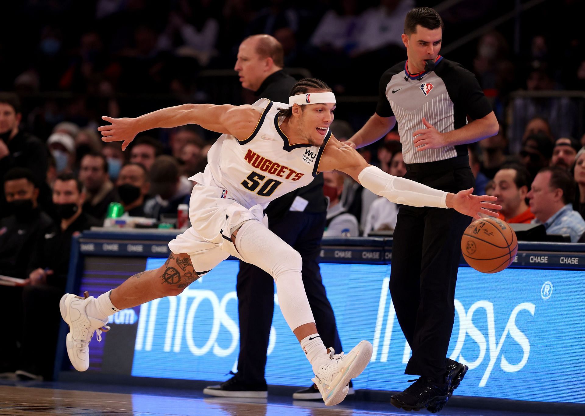 Aaron Gordon of the Denver Nuggets hustles to keep possession of a loose ball