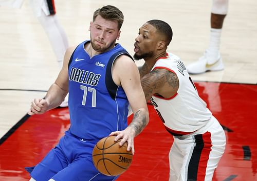 Damian Lillard of the Portland Trail Blazers guards Luka Doncic of the Dallas Mavericks