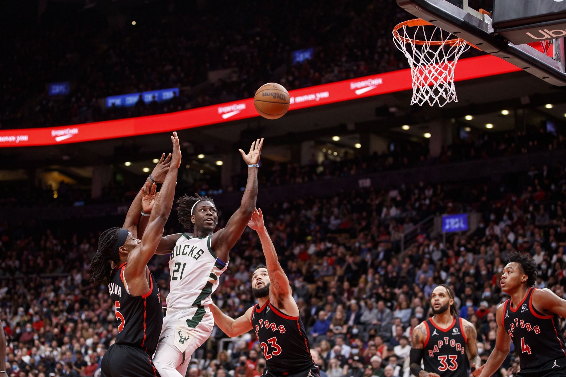 Jrue Holiday of the Milwaukee Bucks contests a shot against the Toronto Raptors