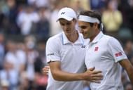 Hubert Hurkacz shakes hands with Roger Federer at Wimbledon 2021