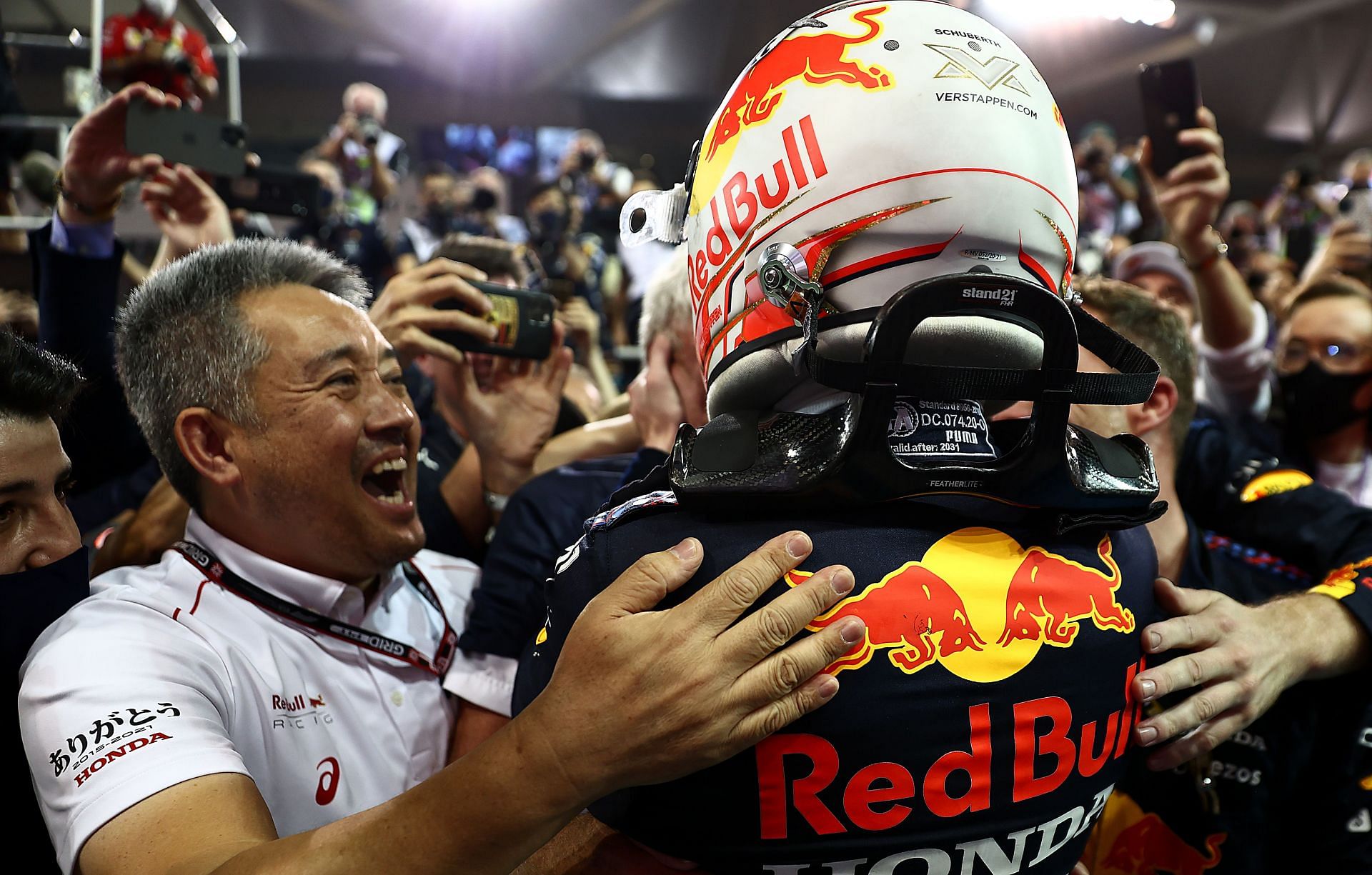 Max Verstappen (right) celebrates his victory with Honda F1 managing director Masashi Yamamoto (left), 2021 Abu Dhabi Grand Prix