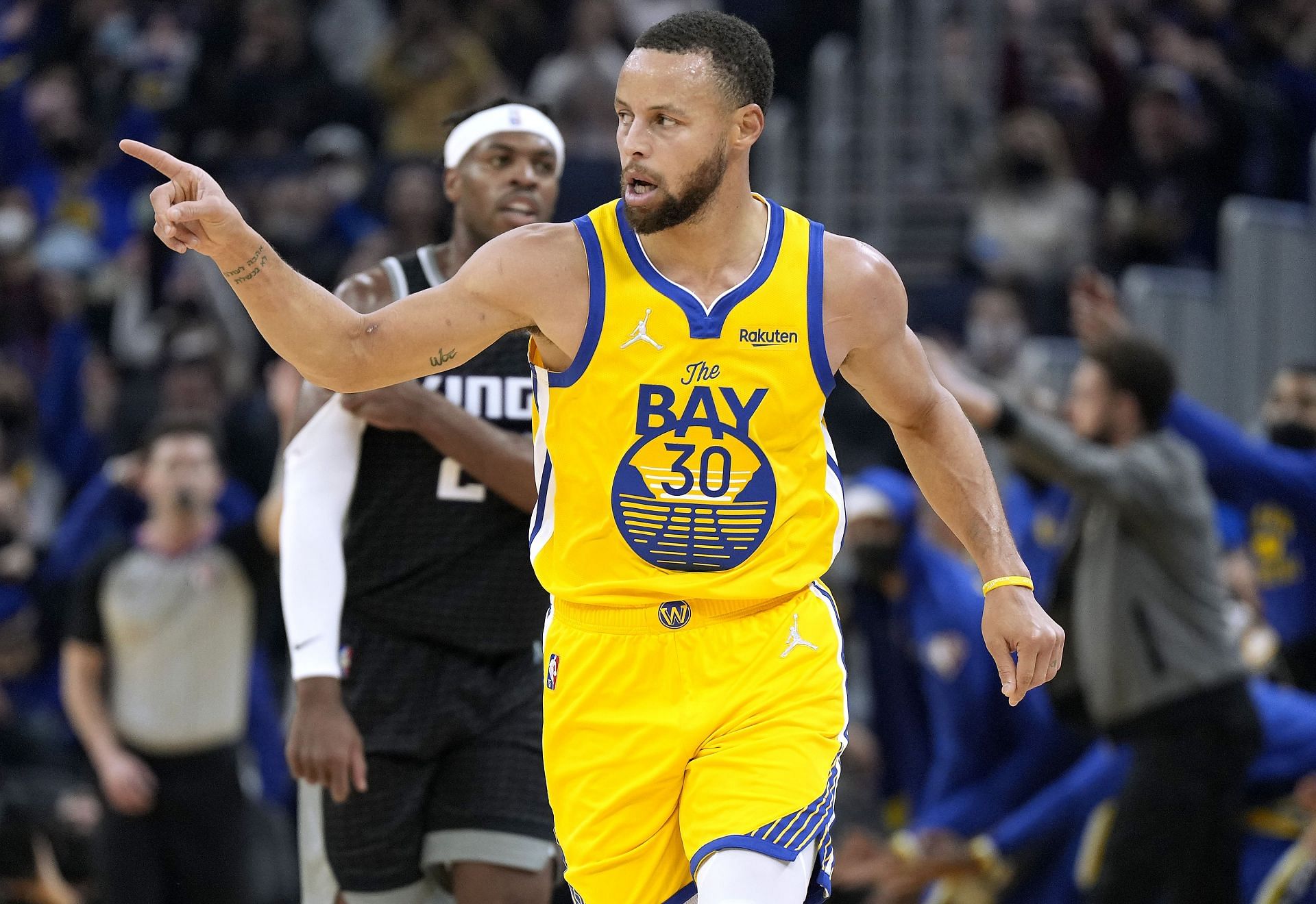 Stephen Curry #30 of the Golden State Warriors reacts after making a three-point shot against the Sacramento Kings during the first quarter at Chase Center on December 20, 2021 in San Francisco, California.
