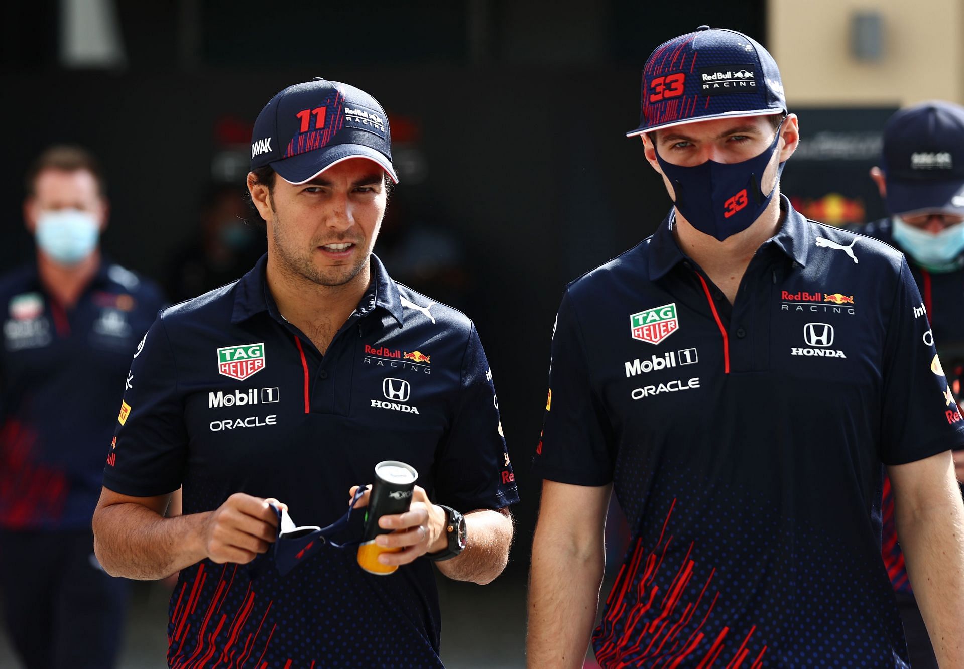 Sergio Perez (left) and Max Verstappen (right) arriving at the paddock at the 2021 Abu Dhabi
