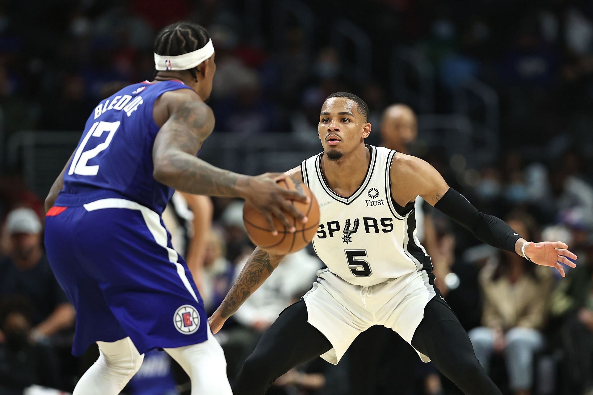 Dejounte Murray of San Antonio Spurs guards Eric Bledsoe of the Los Angeles Clippers