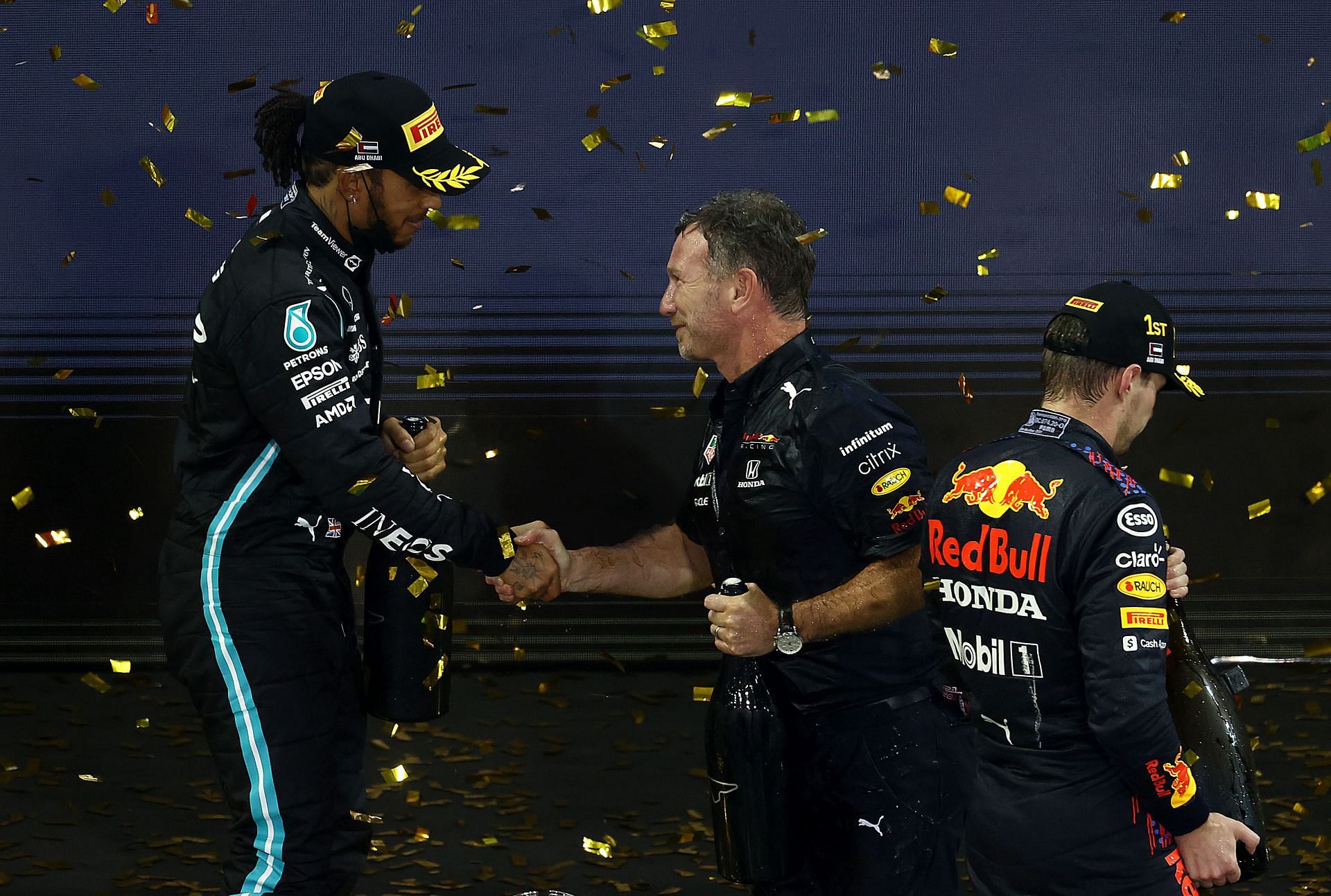 Red Bull Racing Team Principal Christian Horner shakes hands with Lewis Hamilton on the podium during 2021 Abu Dhabi GP. (Photo by Clive Rose/Getty Images)