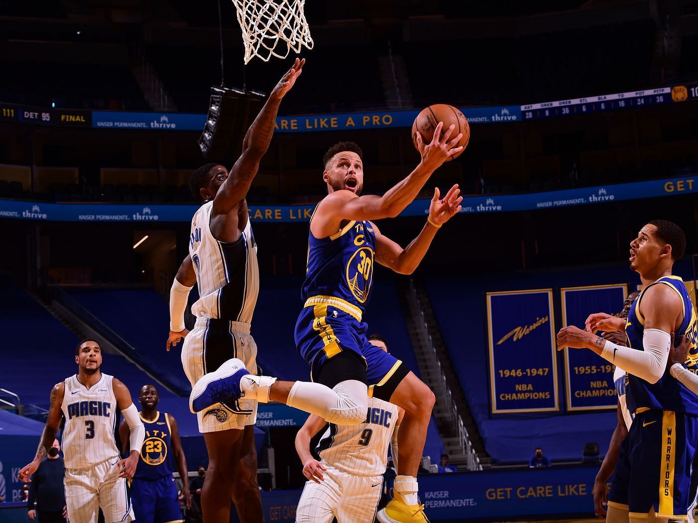 Stephen Curry of the Golden State Warriors scores against the Orlando Magic