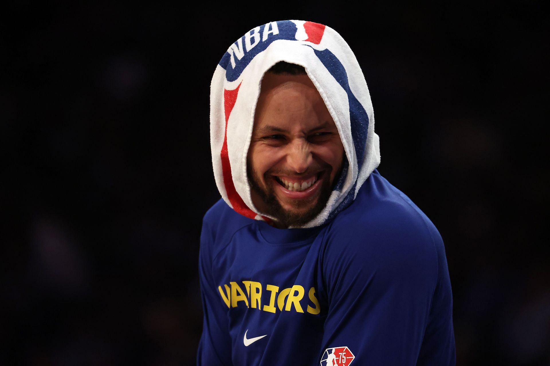 Steph Curry laughs on the sidelines after having broken the all-time three-point record.