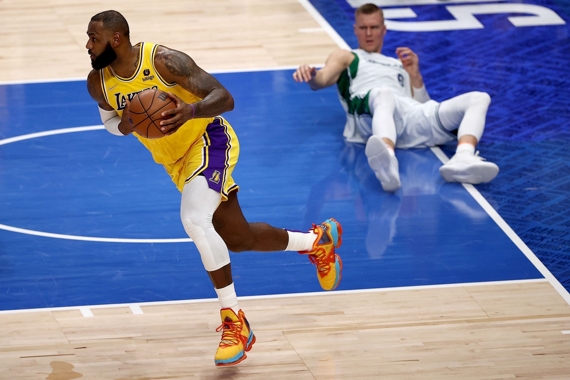 LeBron James #6 of the Los Angeles Lakers rebounds the ball against Kristaps Porzingis #6 of the Dallas Mavericks