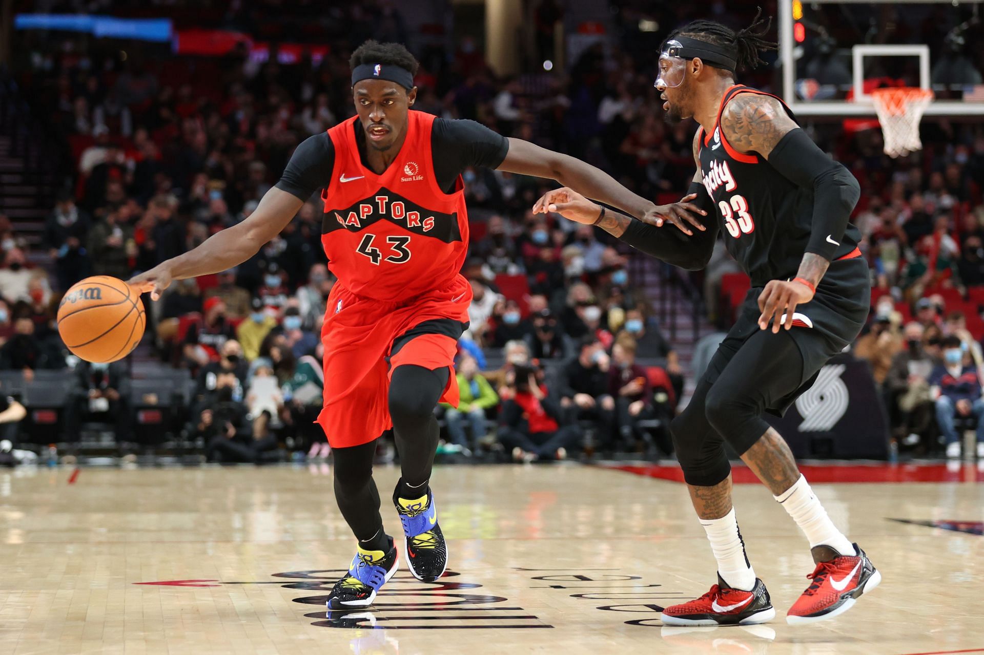 Pascal Siakam #43 of the Toronto Raptors brings the ball up court against Robert Covington #33 of the Portland Trail Blazers during the third quarter at Moda Center on November 15, 2021 in Portland, Oregon.