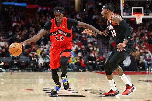 Pascal Siakam #43 of the Toronto Raptors brings the ball up court against Robert Covington #33 of the Portland Trail Blazers during the third quarter at Moda Center on November 15, 2021 in Portland, Oregon.