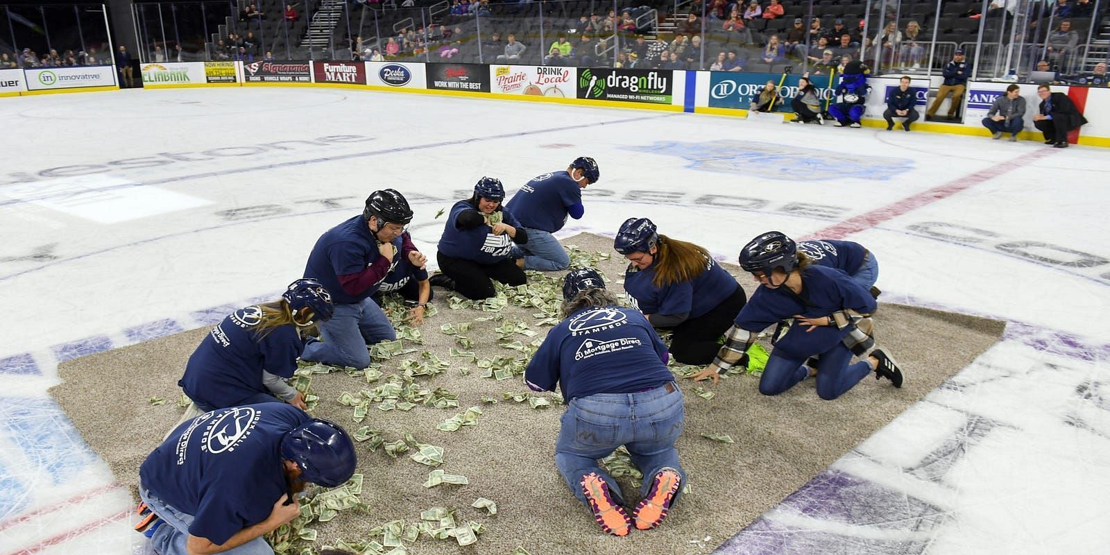 Teachers scramble in a pit, gathering cash for school funds (Image via NoLieWithBTC/ Twitter)