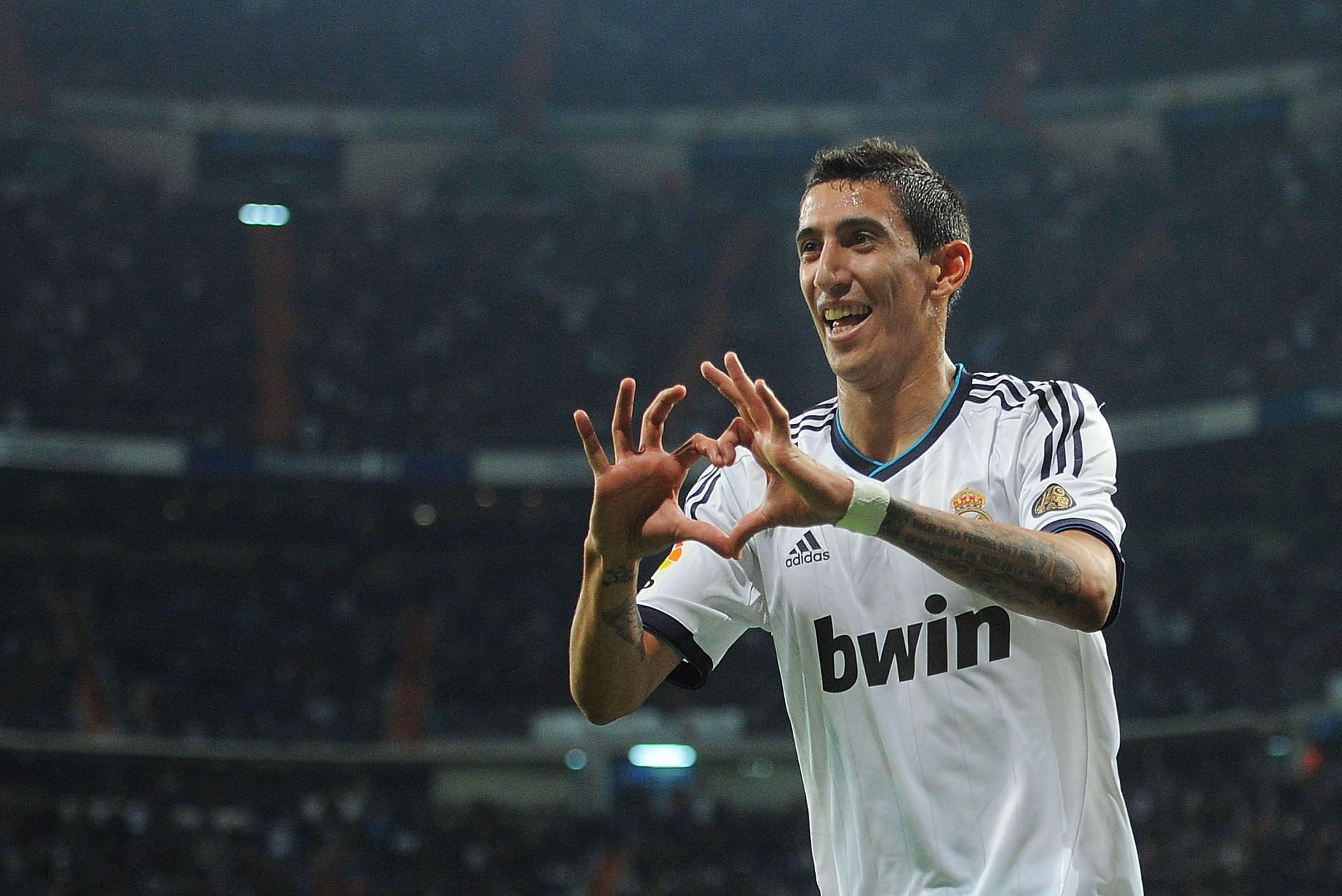 Angel Di Maria posing with his trademark &#039;hand-heart&#039; celebration after scoring a goal for Real Madrid.