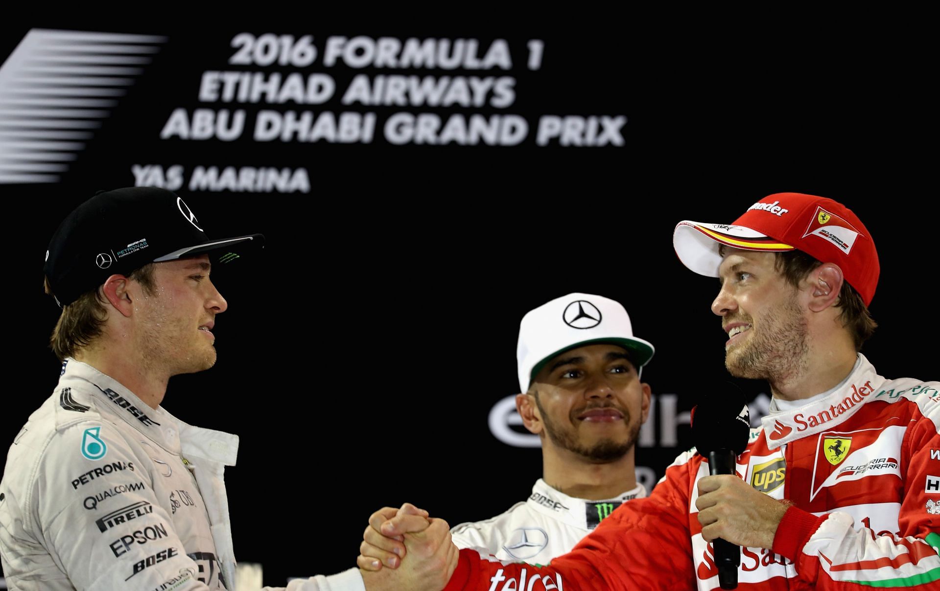 Sebastian Vettel (right) congratulates fellow countryman Nico Rosberg (left) on his maiden World Championship, as Lewis Hamilton (center) watches on.