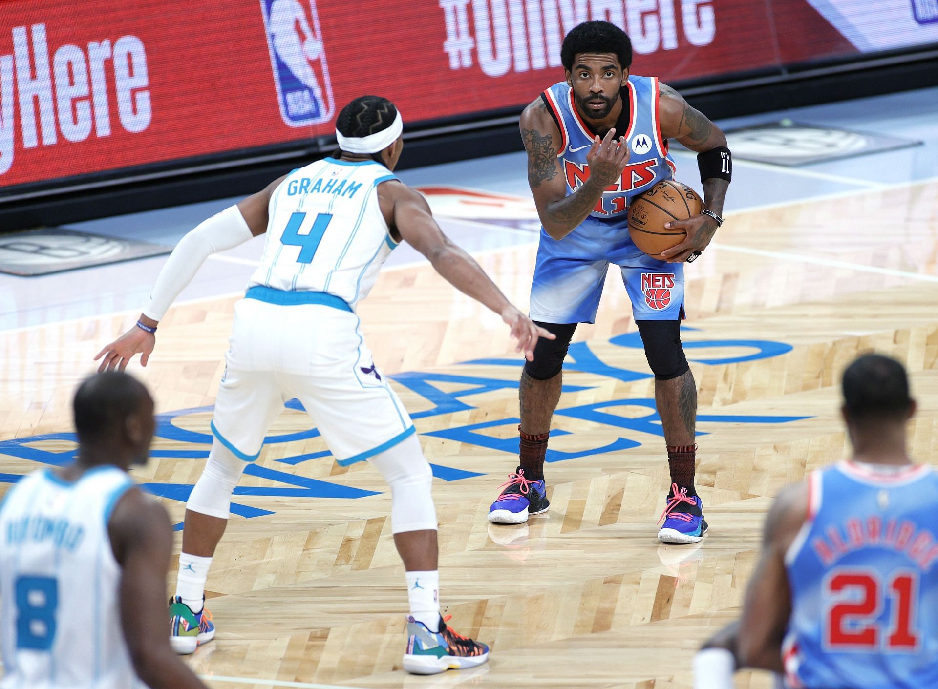 Kyrie Irving #11 of the Brooklyn Nets calls a play as Devonte' Graham #4 of the Charlotte Hornets