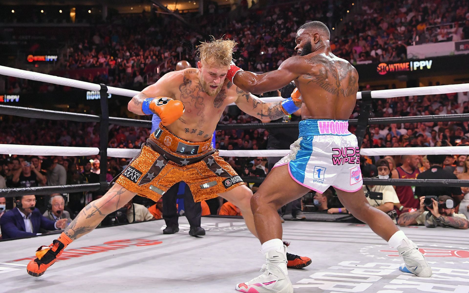 Pro boxing arch rivals Jake Paul (left) and Tyron Woodley (right) in action during their first fight in August
