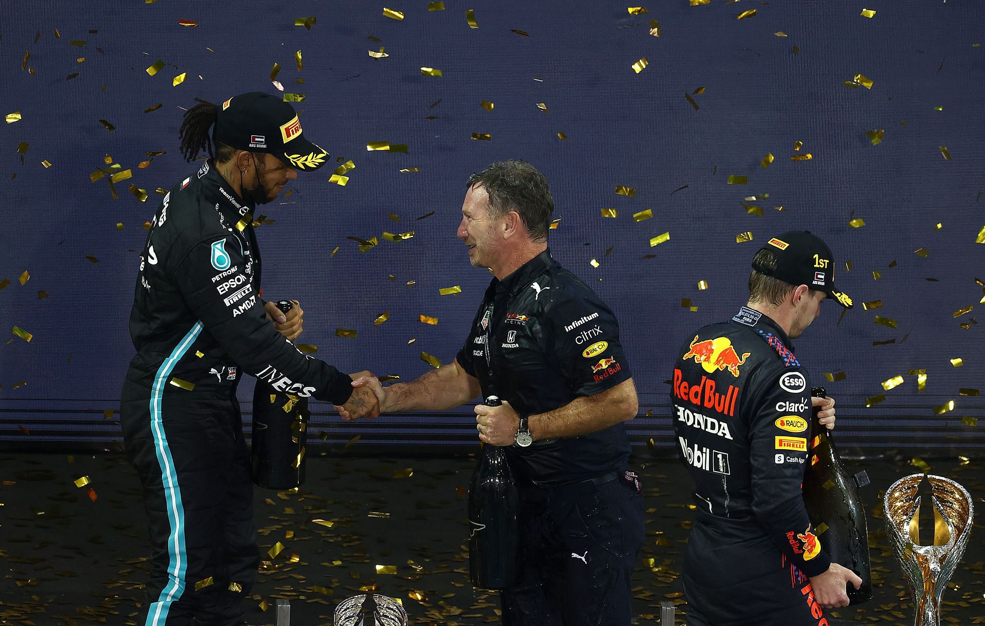 Red Bull Racing Team Principal Christian Horner shakes hands with second-placed Lewis Hamilton on the podium during the 2021 Abu Dhabi Grand Prix. (Photo by Clive Rose/Getty Images)