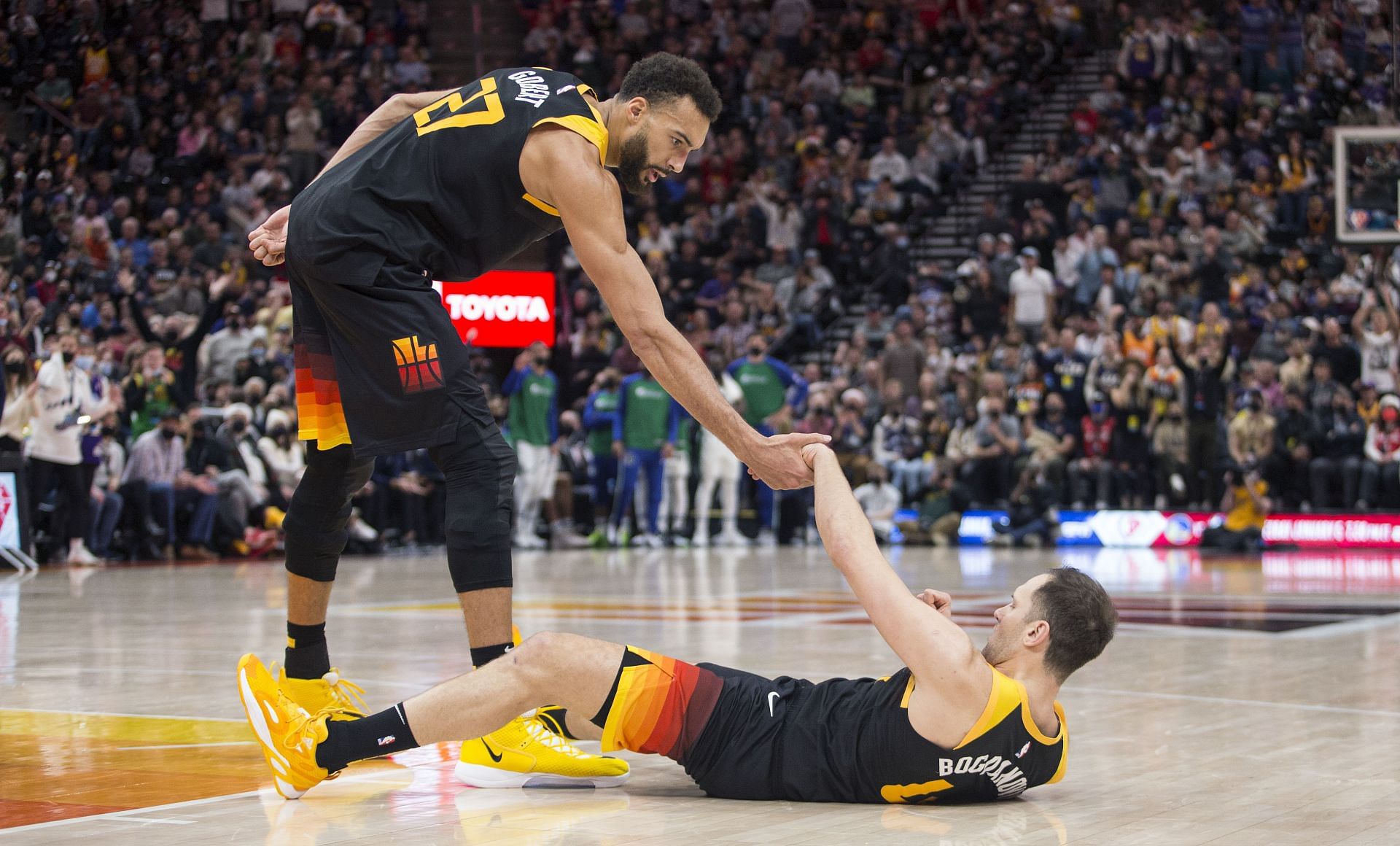 Rudy Gobert of the Utah Jazz helps up teammate Bojan Bogdanovic