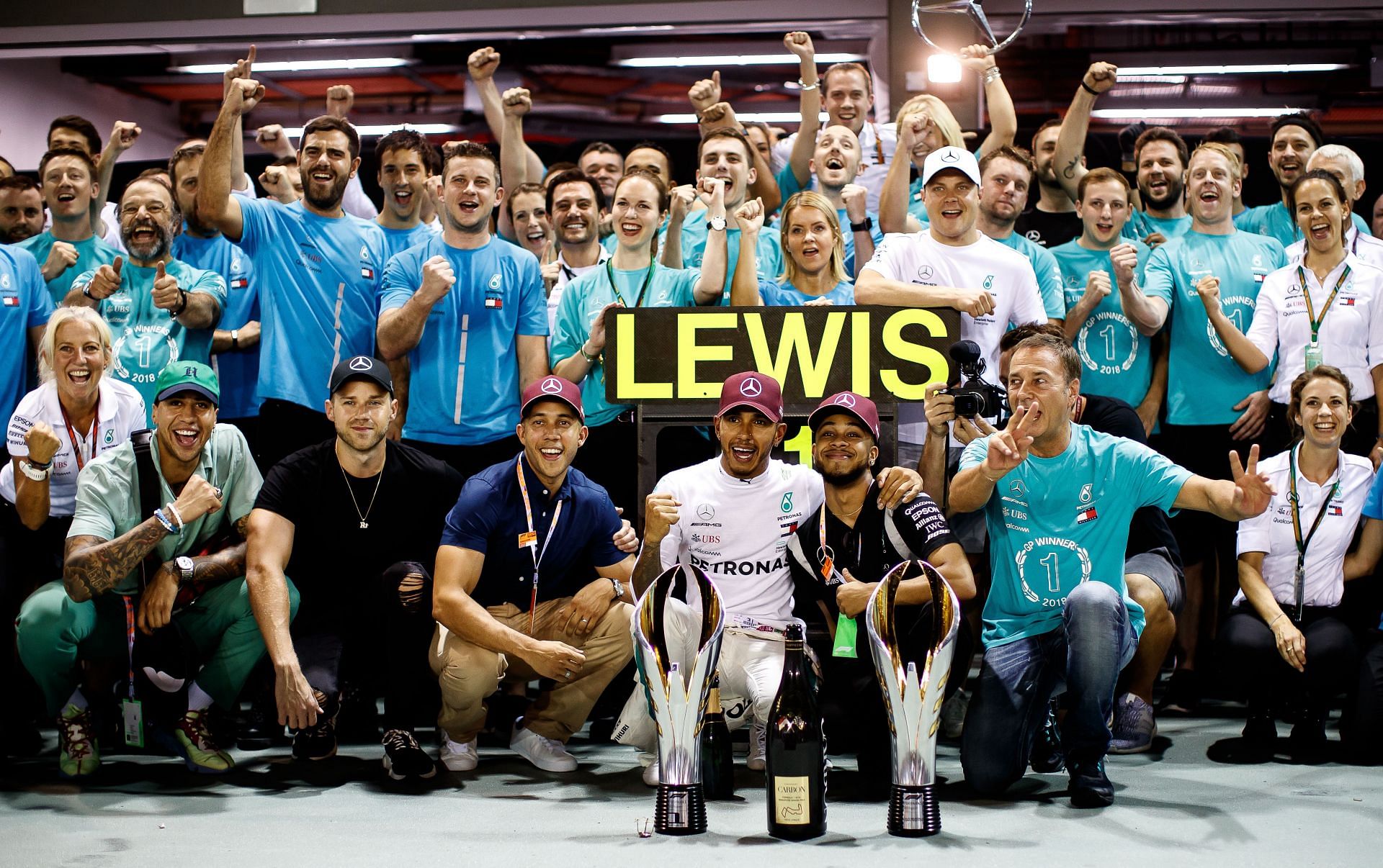 F1 Grand Prix of Singapore - Lewis Hamilton celebrates with his team after winning.