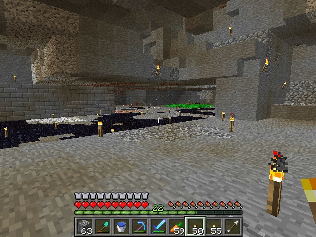 Cave lit up with torches (Image via Minecraft)