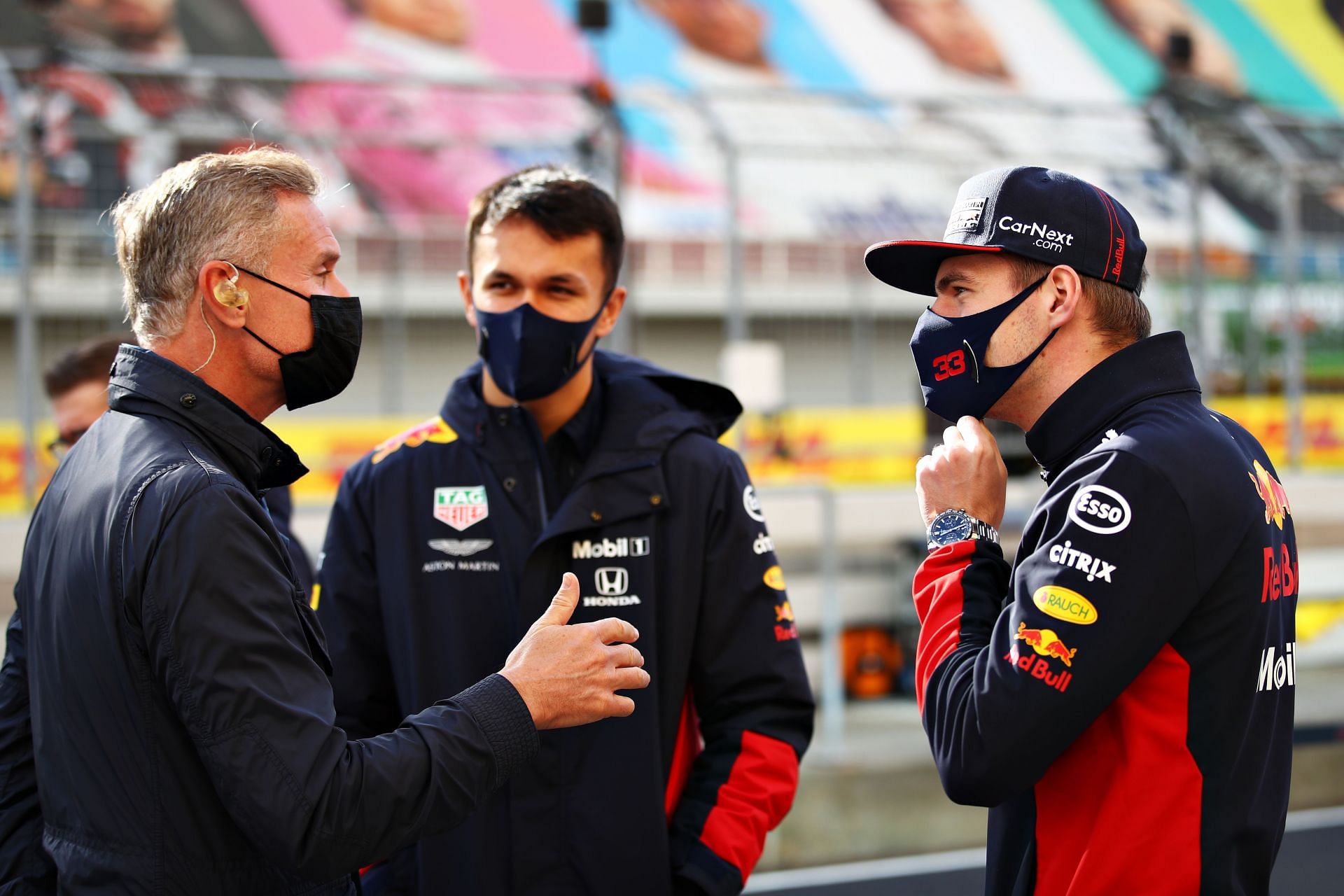 (L-R) David Coulthard talks with Alex Albon and Max Verstappen in the pitlane. (Photo by Bryn Lennon/Getty Images