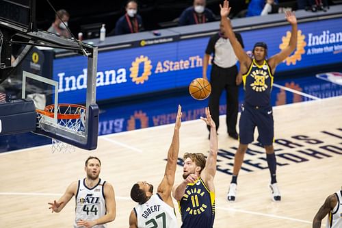 Domantas Sabonis goes up against Rudy Gobert as Myles Turner celebrates; Utah Jazz v Indiana Pacers