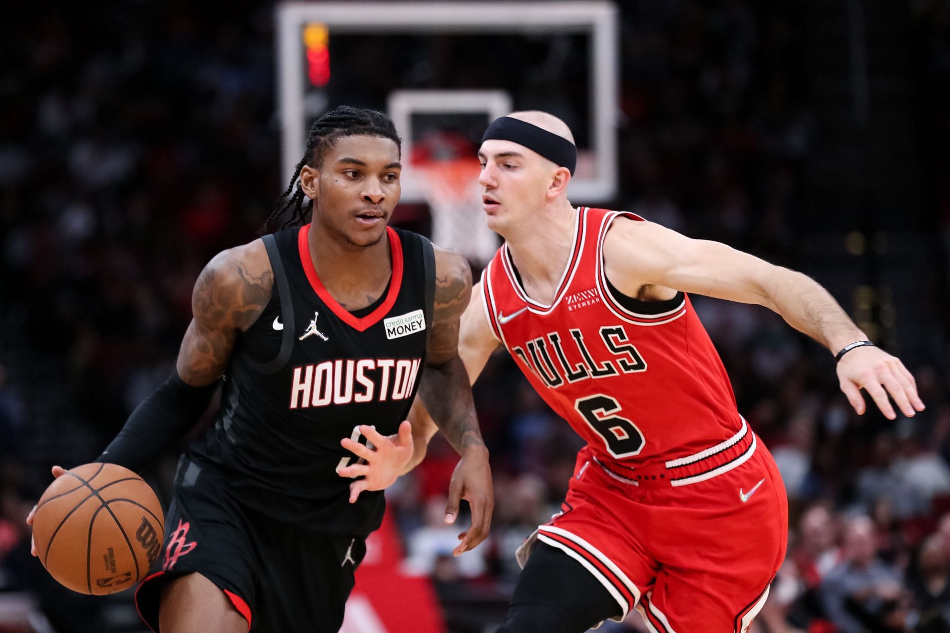 Kevin Porter Jr. of the Houston Rockets drives past Alex Caruso of the Chicago Bulls