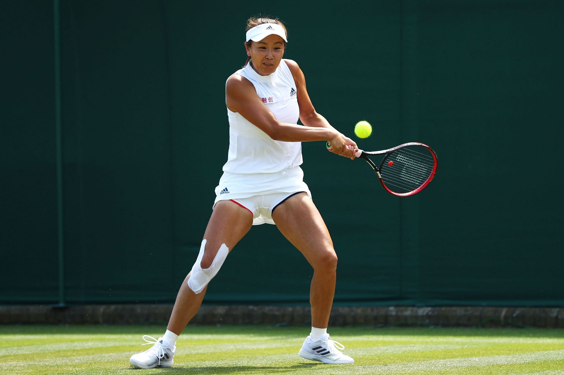 Peng Shuai returns against Sam Stosur at the 2018 Wimbledon Championships