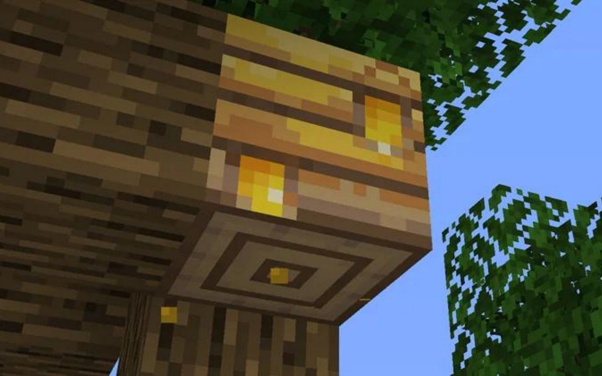 Honey can be seen dripping out of the hive (Image via Minecraft Wiki)