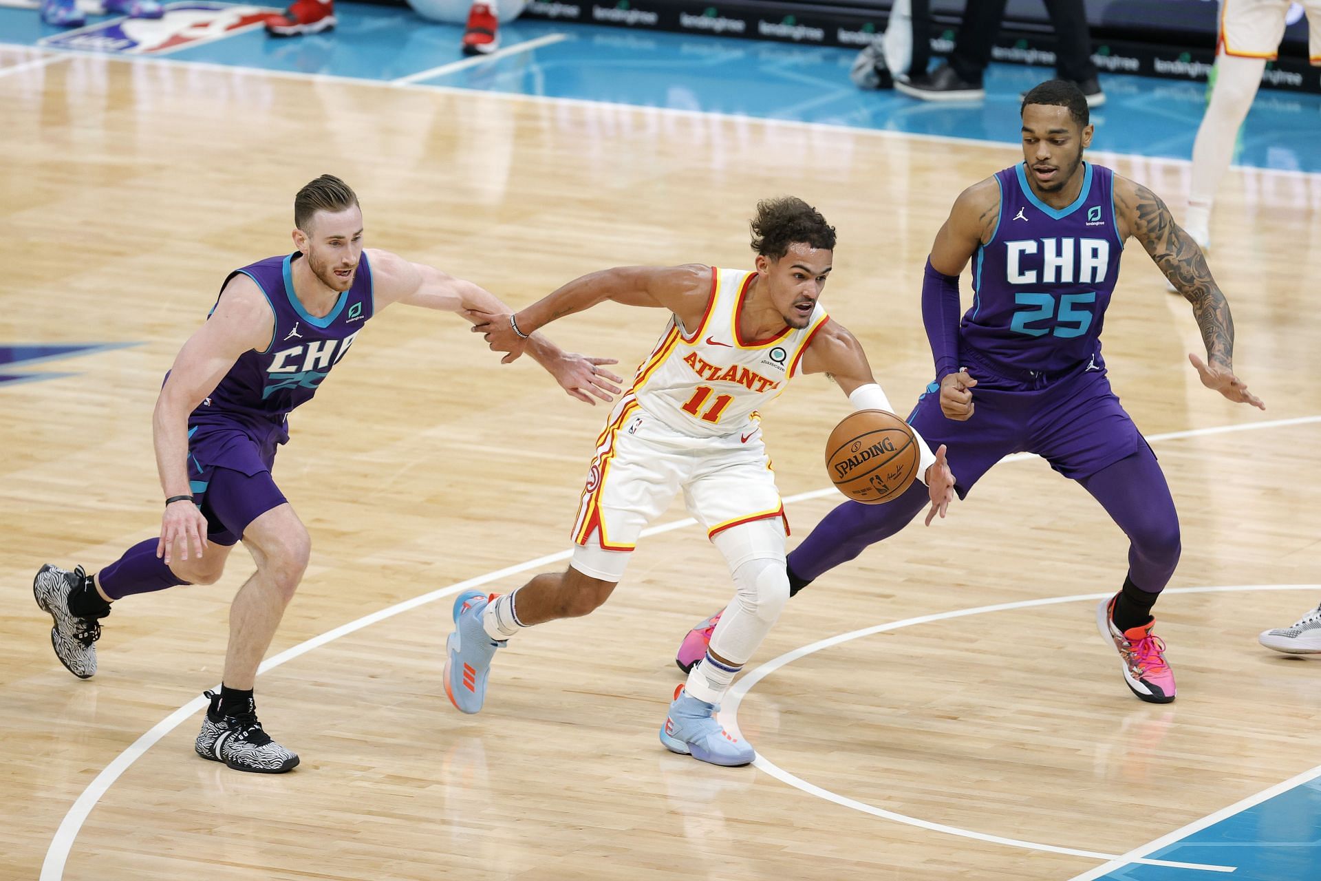 Trae Young of the Atlanta Hawks drives past the Charlotte Hornets