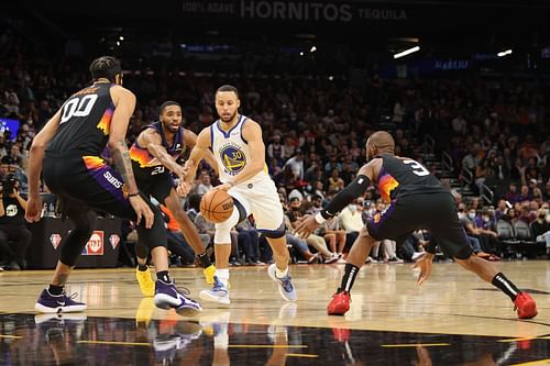 Stephen Curry guarded by three Phoenix Suns players