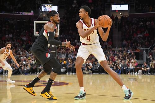 Robert Covington #33 of the Portland Trail Blazers guards Evan Mobley #4 of the Cleveland Cavaliers