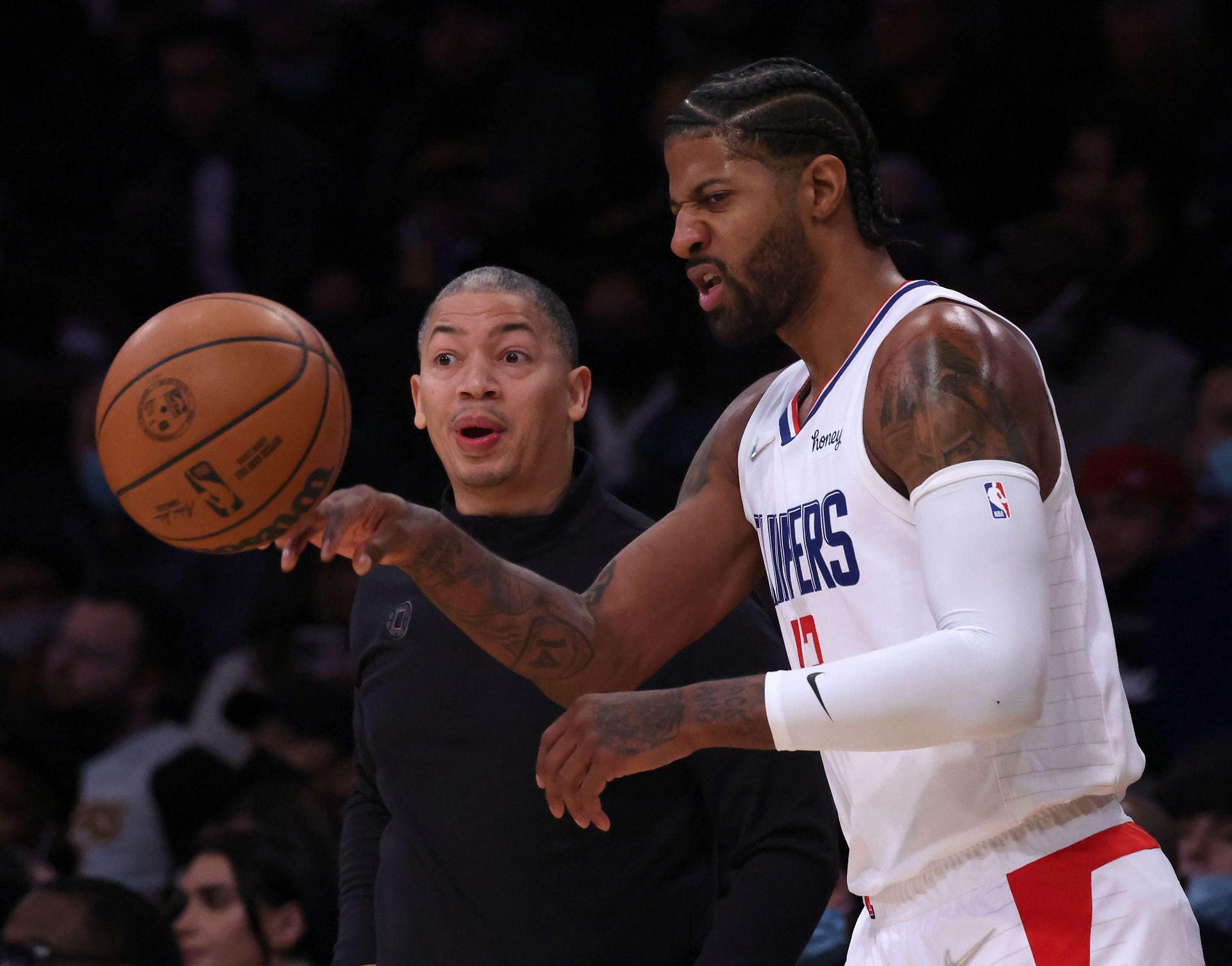 Head coach Tyronn Lue of the LA Clippers calls a play in front of Paul George #13 during the first half against the Los Angeles Lakers at Staples Center on December 03, 2021 in Los Angeles, California.