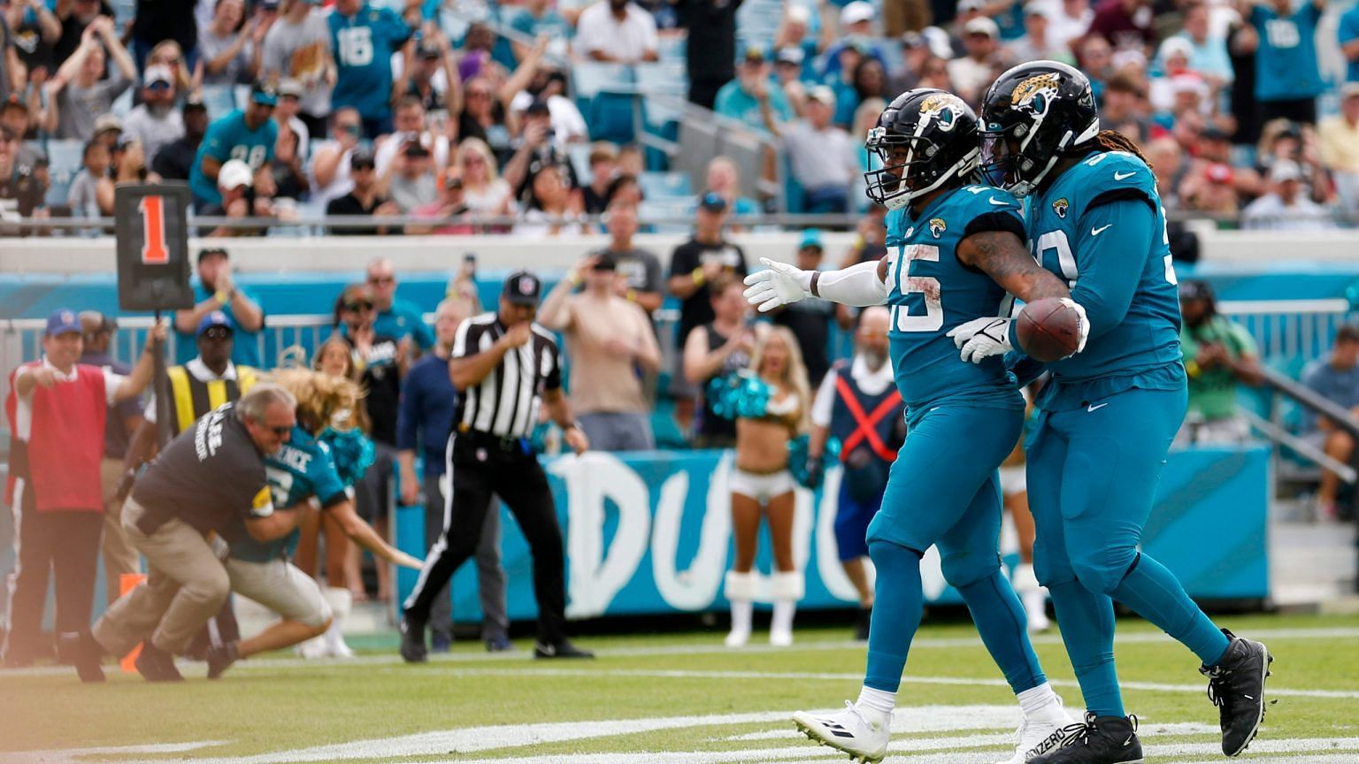 A Jaguars fan runs into the endzone for a pass on a touchdown play