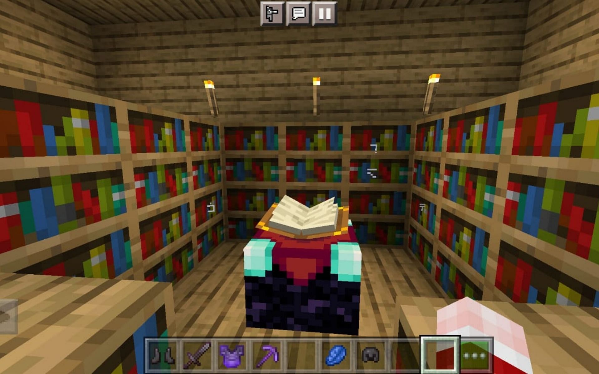 Enchanting table surrounded by bookshelves (Image via Minecraft)