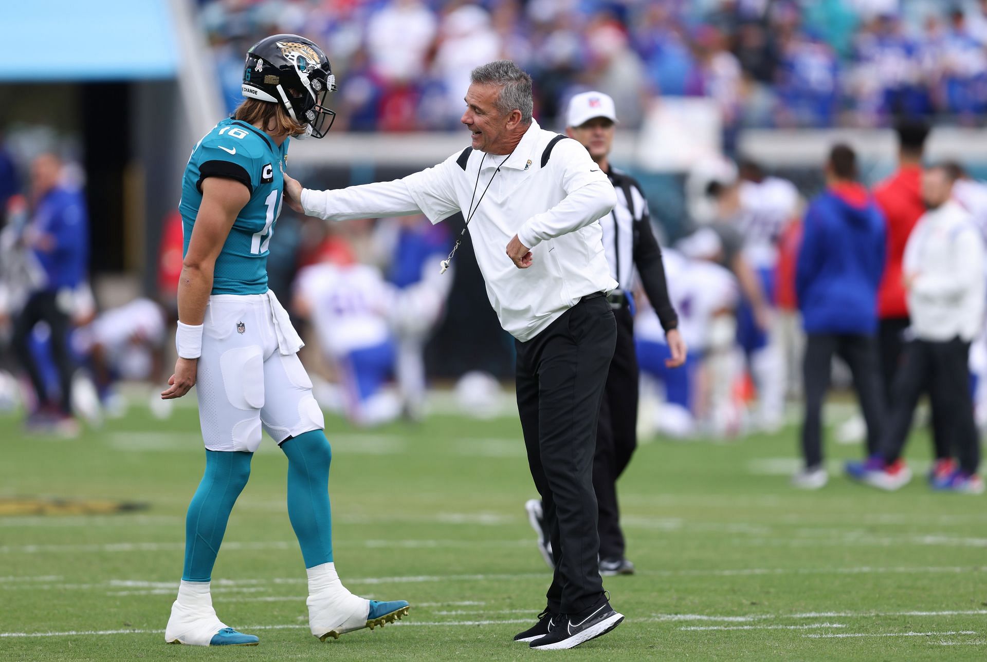 Trevor Lawrence and Urban Meyer chat before a game