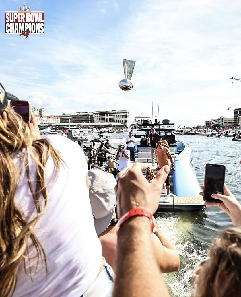 Tom Brady throws Super Bowl trophy to teammates on another boat