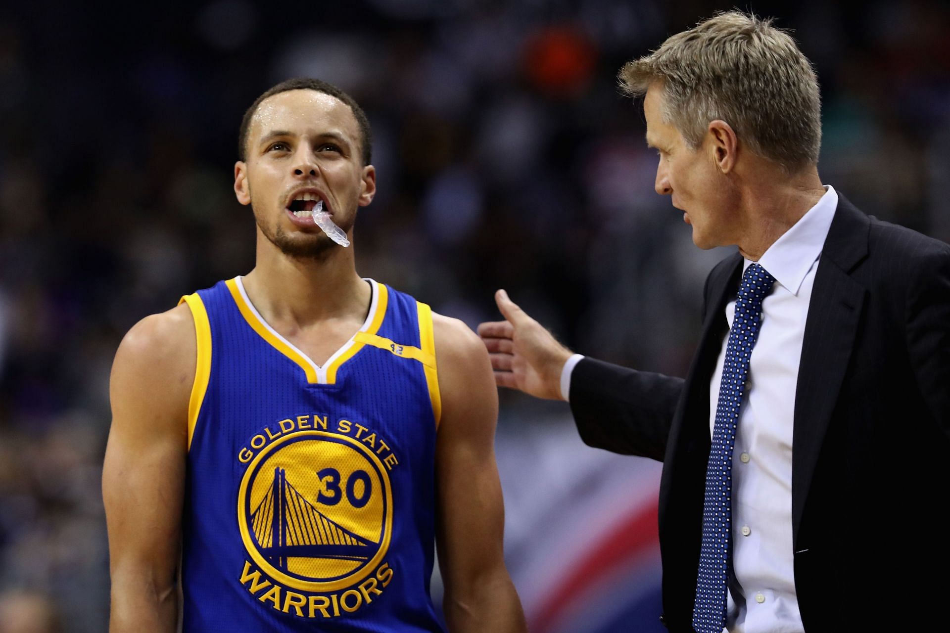 Stephen Curry #30 of the Golden State Warriors talks with head coach Steve Kerr during a first half time out against the Washington Wizards at Verizon Center on February 28, 2017 in Washington, DC.