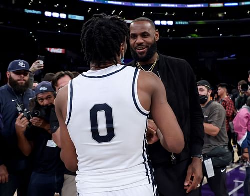 LeBron James #6 of the Los Angeles Lakers talks with his son Bronny James #0 of Sierra Canyon