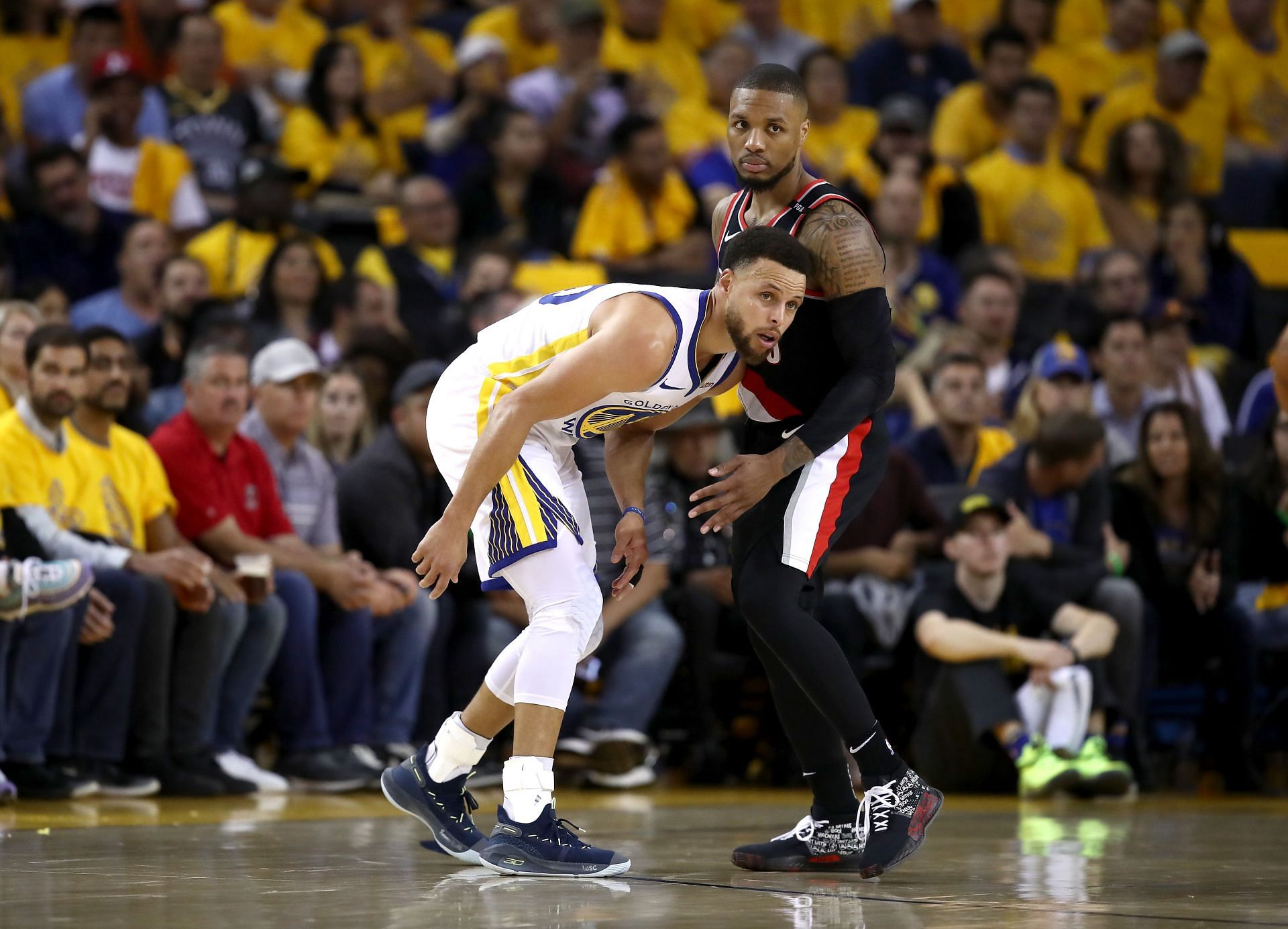 Stephen Curry #30 of the Golden State Warriors matching up against Damian Lillard #0 of the Portland Trail Blazers
