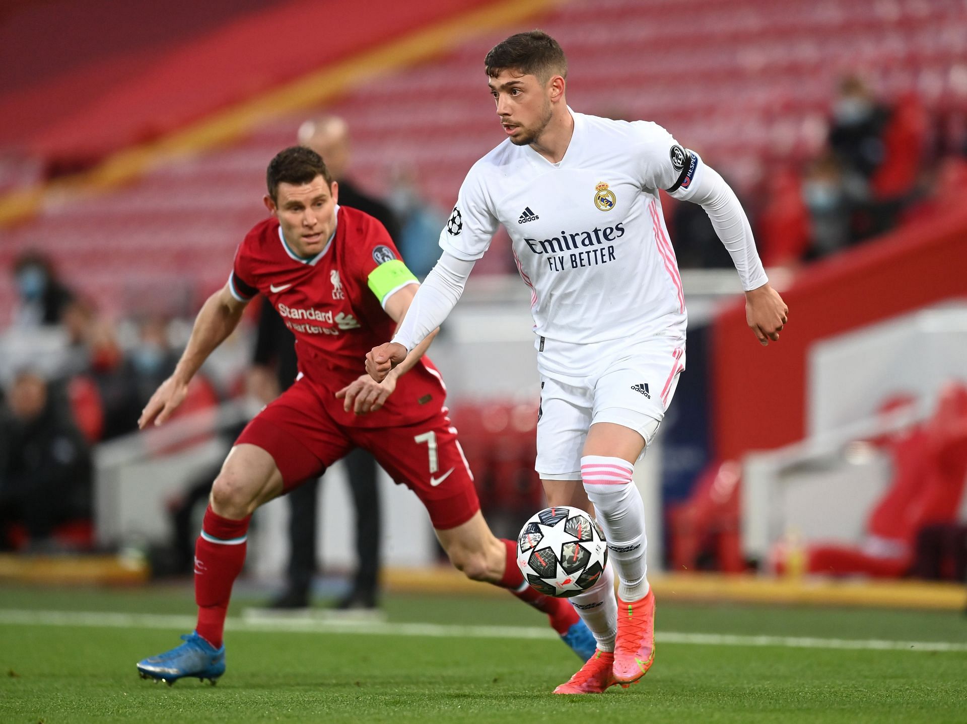 Federico Valverde (R) of Real Madrid shields the ball from Liverpool&#039;s James Milner (#7)