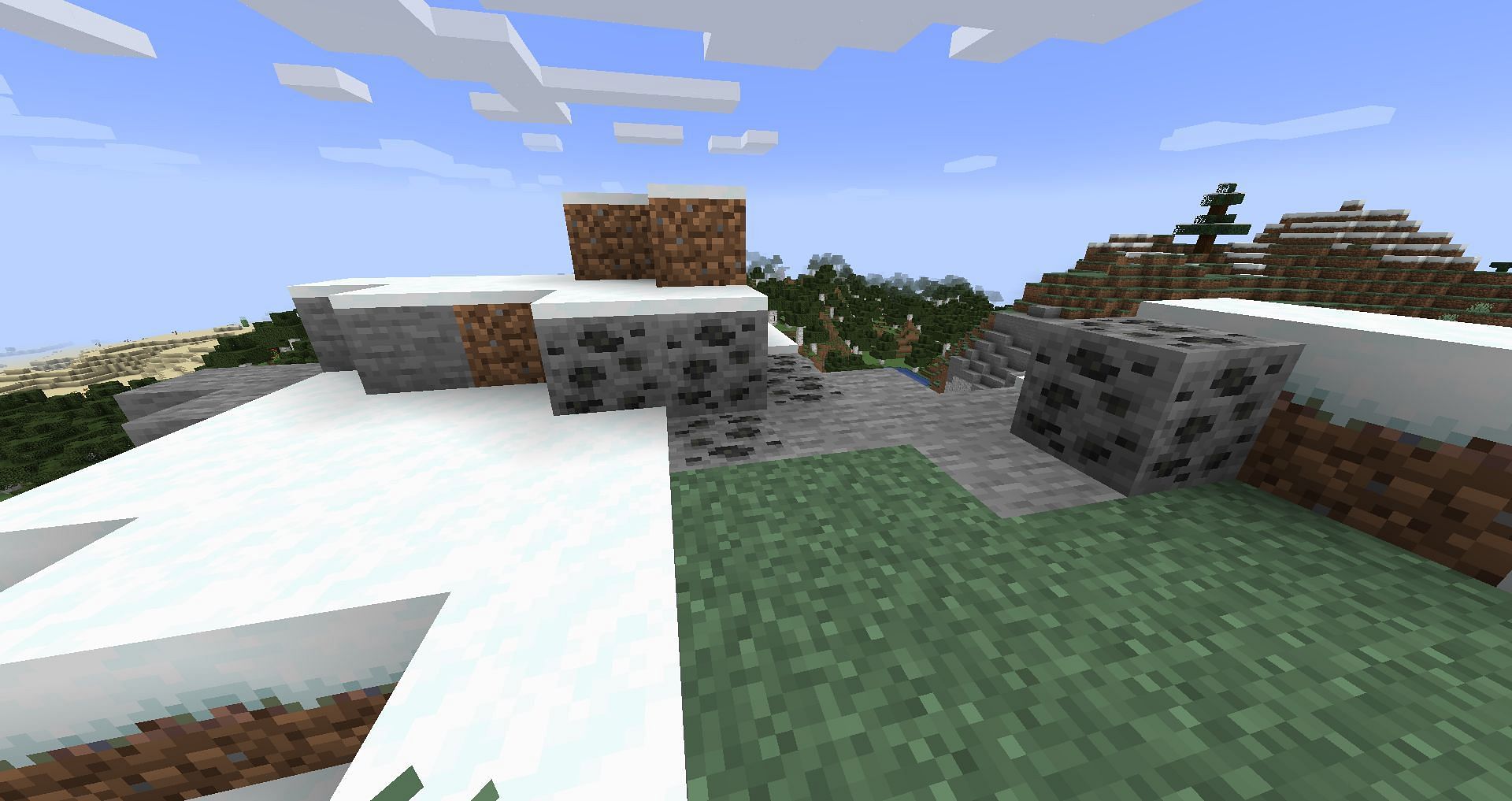 Coal ores on a mountain (Image via Minecraft Wiki)