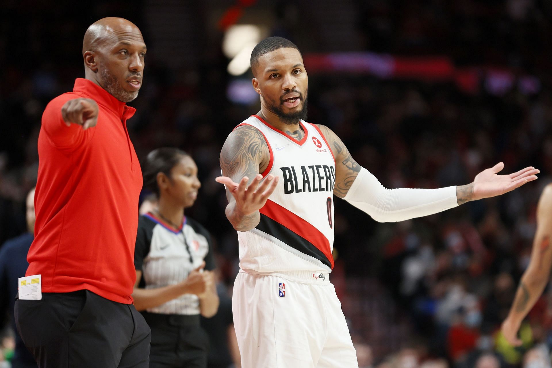 Head coach Chauncey Billups and Damian Lillard #0 of the Portland Trail Blazers