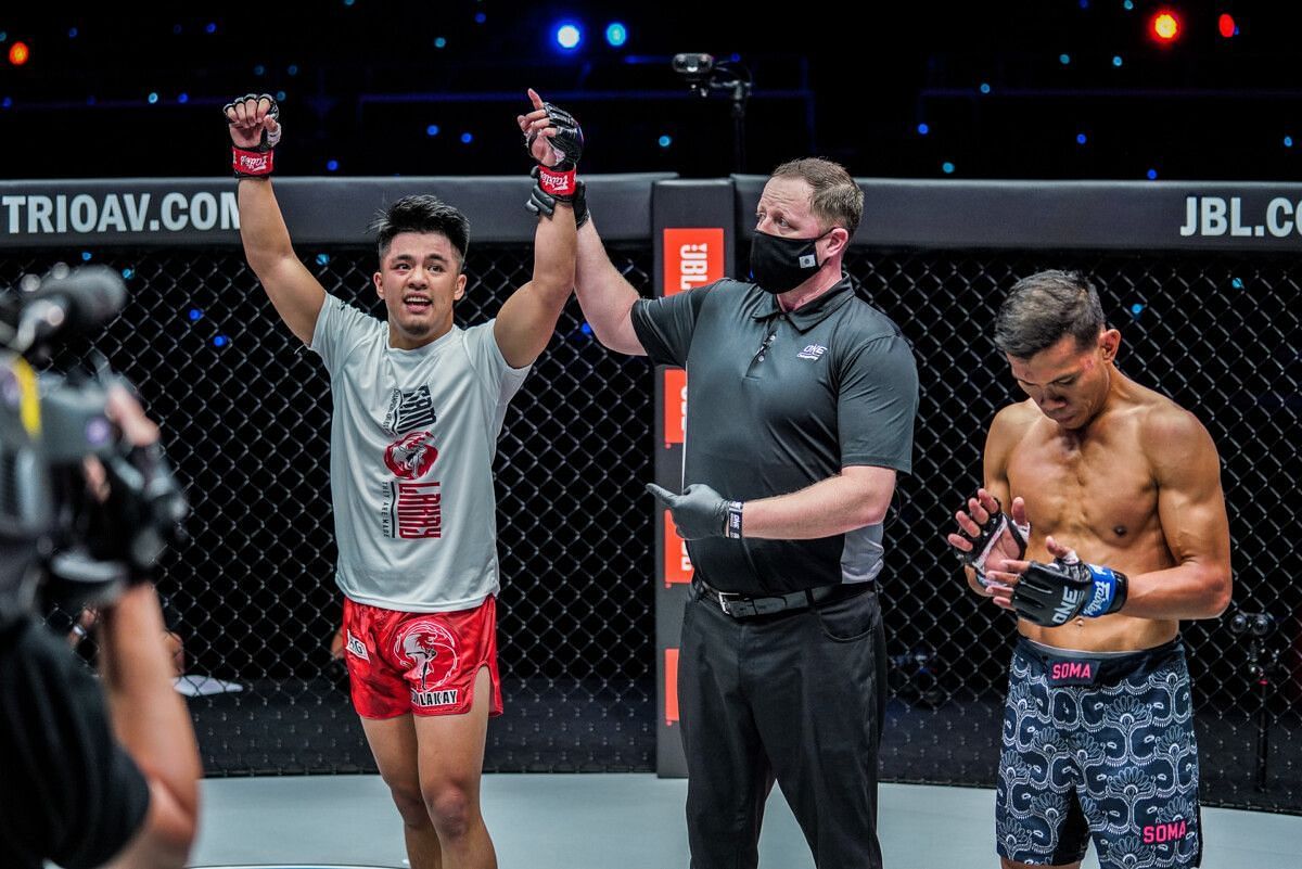 Jhanlo Sangiao (Left) gets his hands raised in victory against Paul Lumihi (Right) | [Photo: ONE Championship]