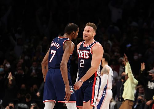 Kevin Durant #7 and Blake Griffin #2 of the Brooklyn Nets celebrate a three pointer by Griffen against the Philadelphia 76ers during their game at Barclays Center on December 16, 2021 in New York City.