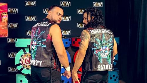 Santana and Ortiz posing backstage at an AEW event