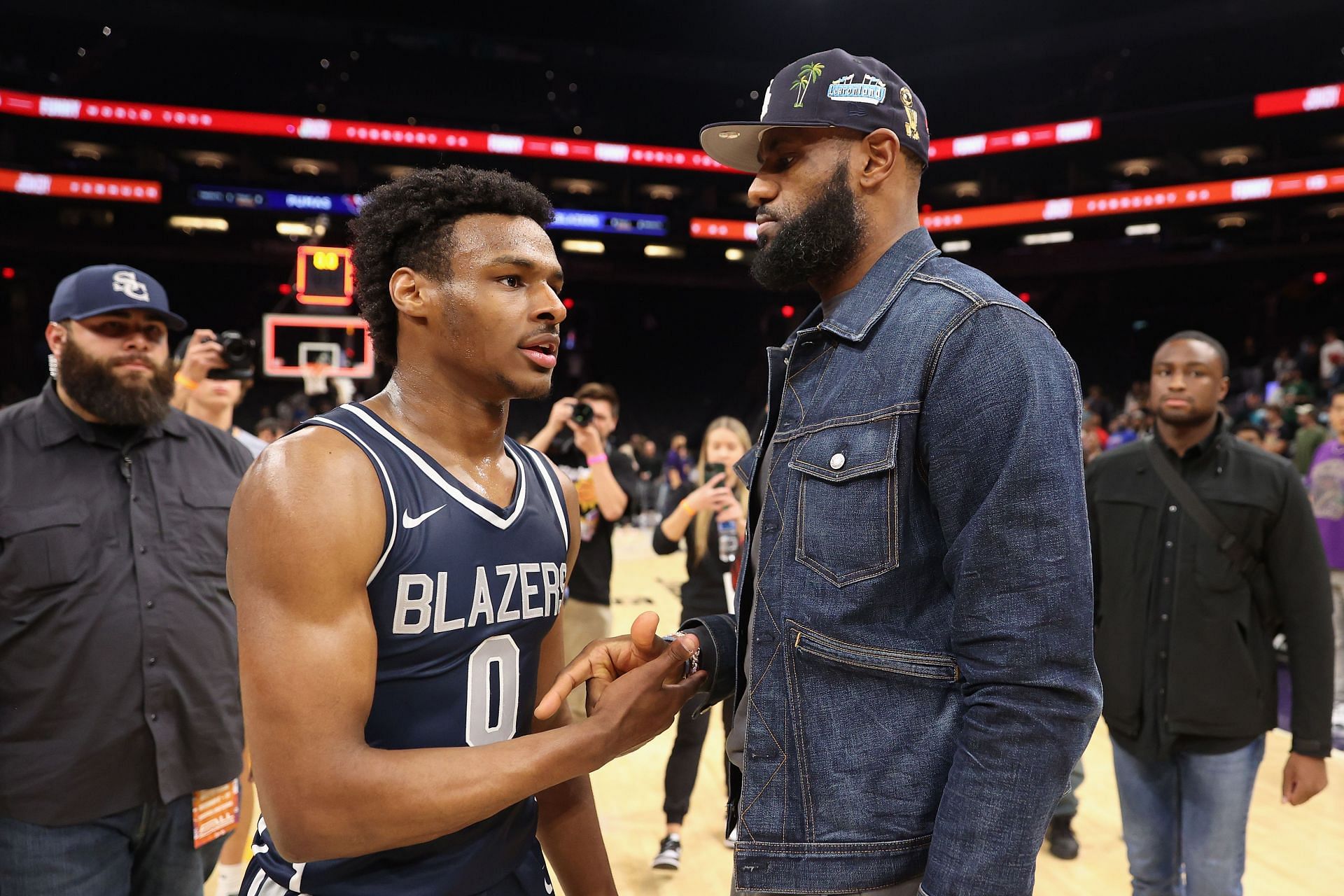 Bronny James and LeBron James after a basketball game.