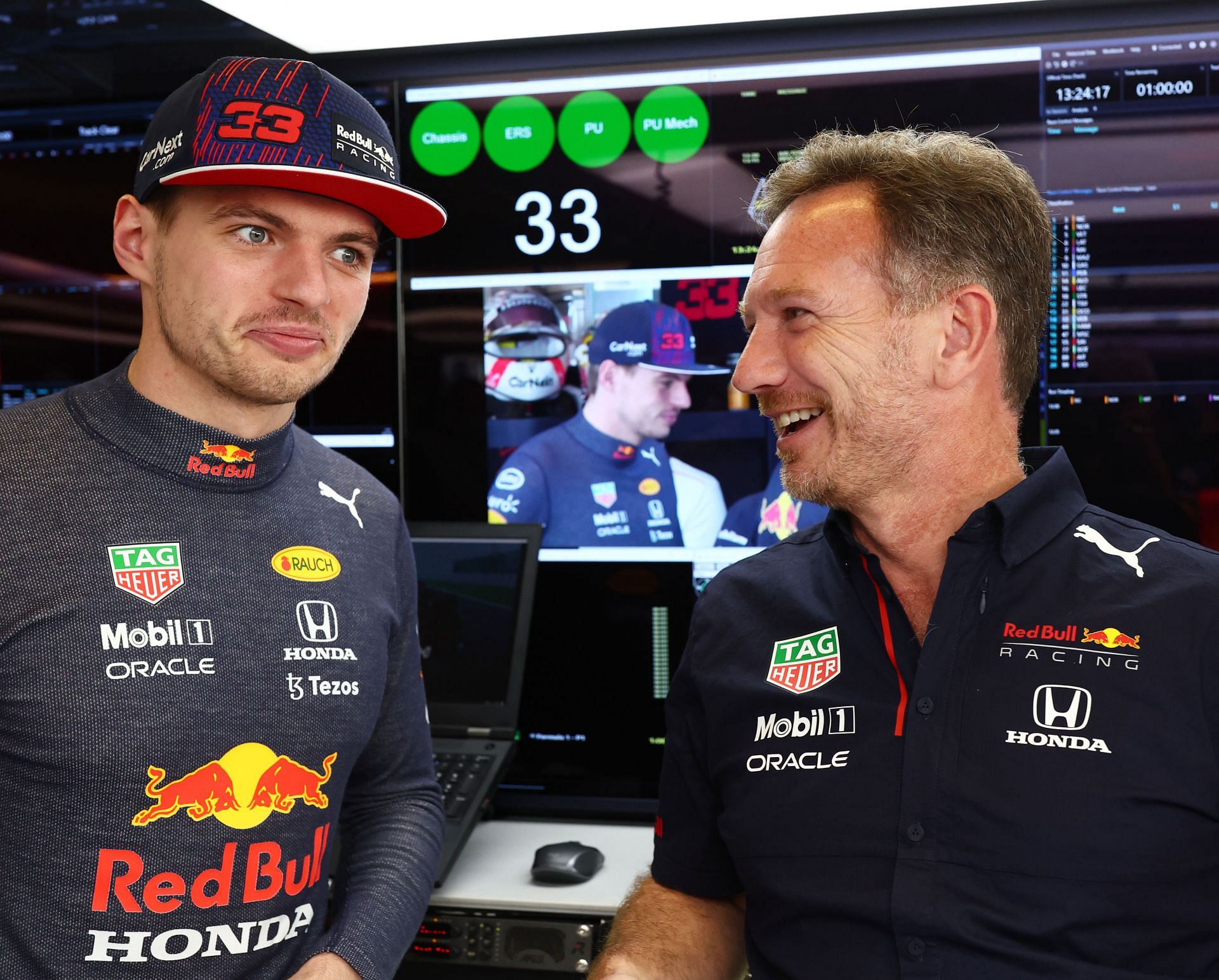 Max Verstappen and Red Bull Racing Team Principal Christian Horner talk in the garage during practice ahead of the 2021 Abu Dhabi Grand Prix. (Photo by Mark Thompson/Getty Images)